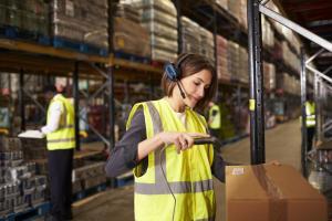 Woman using a barcode reader in a distribution warehouse