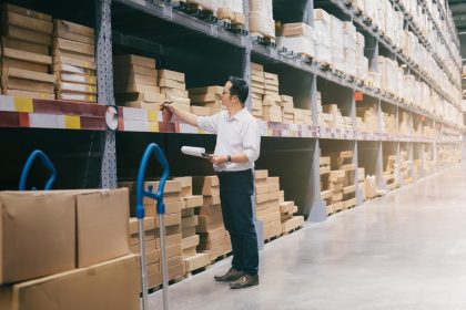 man-warehouse-worker-checking-goods-at-warehouse-J24HEFK Order Fulfilment and Automated Shipping