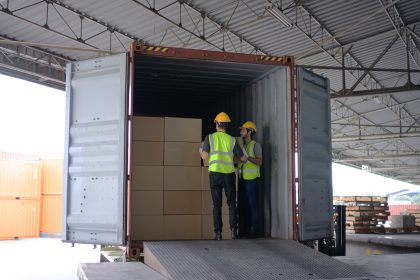 Blue collar workers are working at warehouse. FTZ Advantages