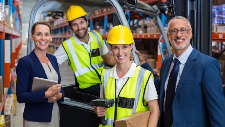 Warehouse manager and client standing with co-workers 4PL supply chain resilience